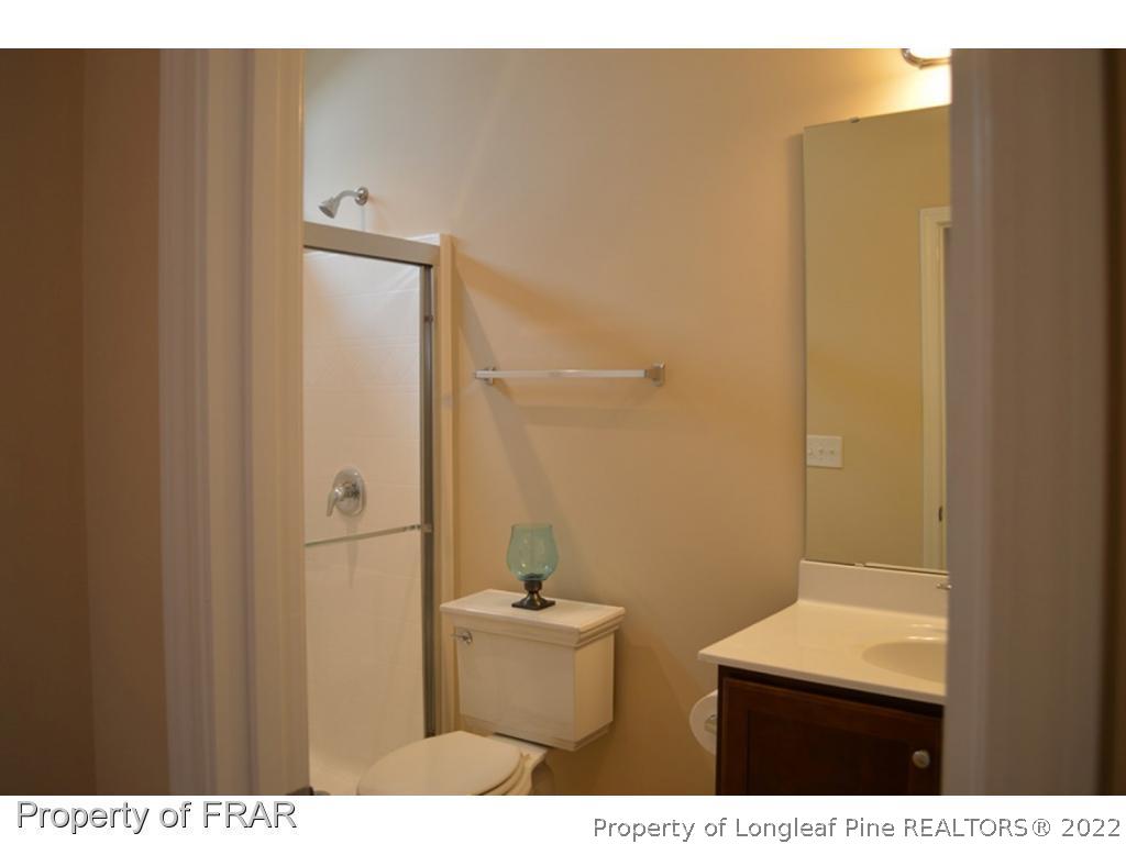 1105 Micahs Way North Spring Lake, NC 28390 - Photo 17 of 32 a bathroom with a sink mirror and toilet