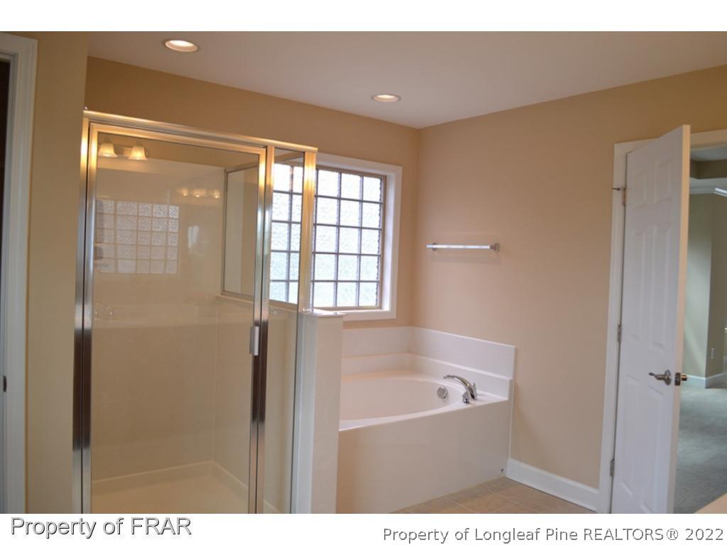 1105 Micahs Way North Spring Lake, NC 28390 - Photo 20 of 32 a bathroom with a bathtub and a shower