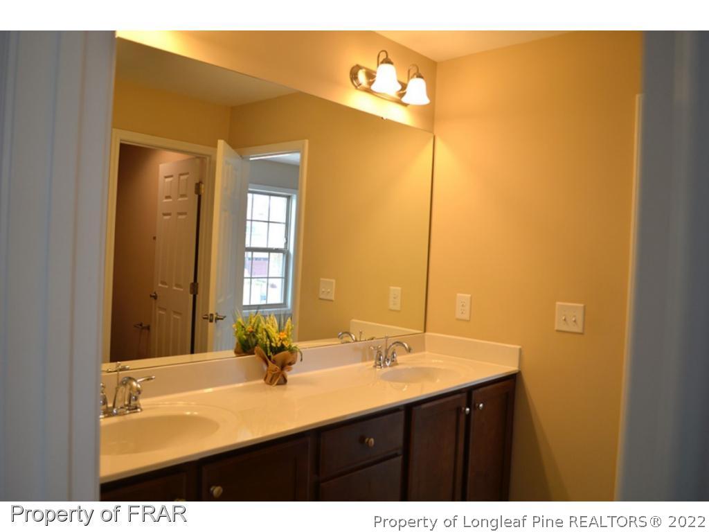 1105 Micahs Way North Spring Lake, NC 28390 - Photo 22 of 32 a bathroom with a sink and a mirror