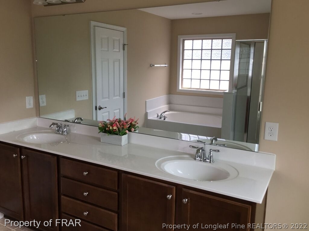 1105 Micahs Way North Spring Lake, NC 28390 - Photo 27 of 32 a bathroom with double vanity and a mirror