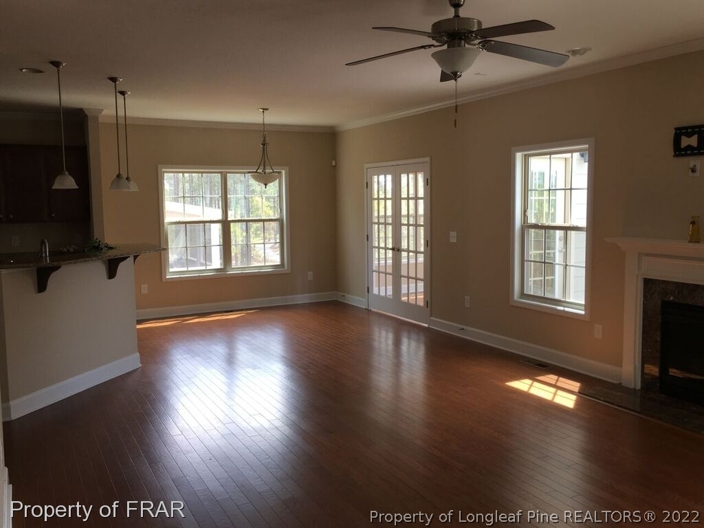 1105 Micahs Way North Spring Lake, NC 28390 - Photo 30 of 32 a view of an empty room with wooden floor and a window