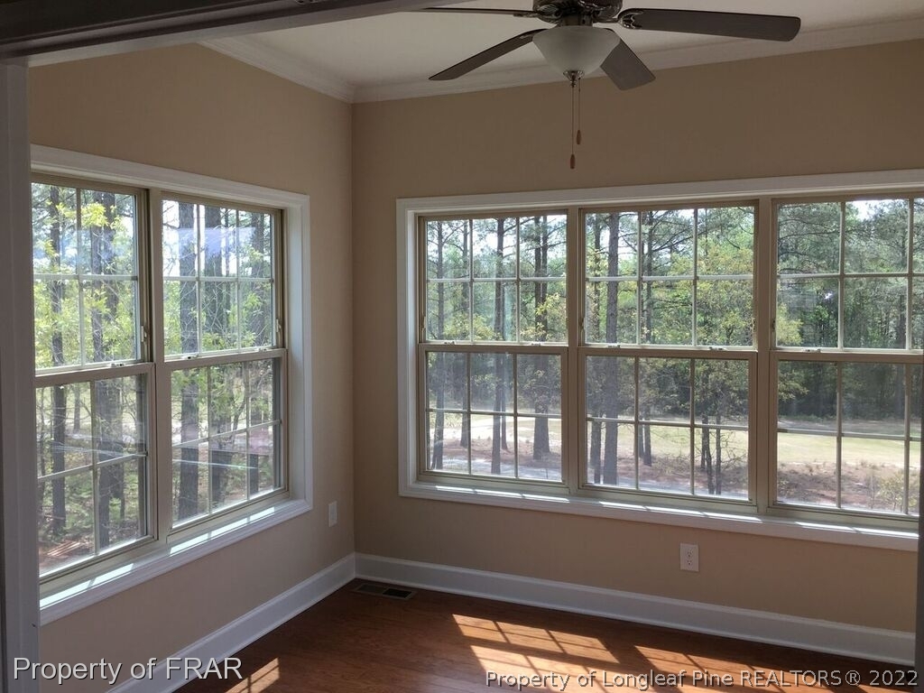 1105 Micahs Way North Spring Lake, NC 28390 - Photo 31 of 32 a view of empty room with wooden floor and fan