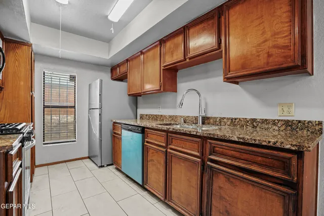 a kitchen with stainless steel appliances granite countertop a stove top oven microwave and cabinets