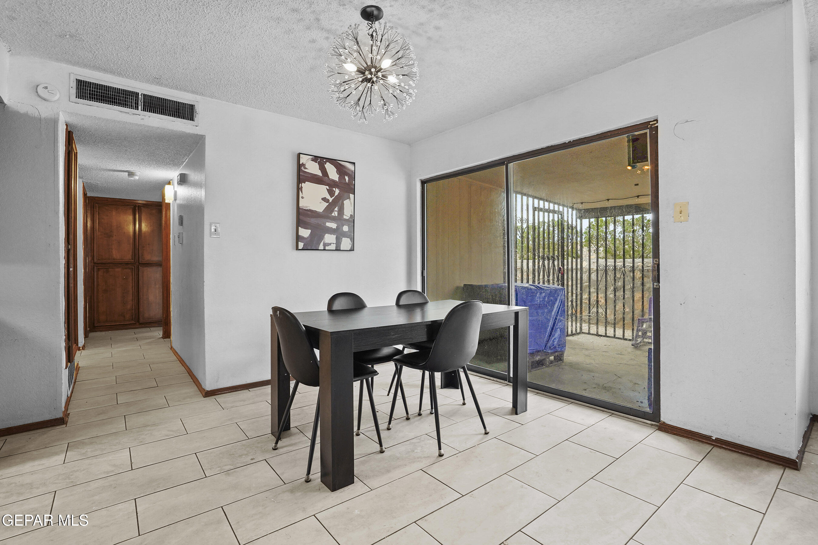 6900 Ridge Top Drive El Paso, TX 79904 - Photo 13 of 32 a view of a dining room with furniture and chandelier