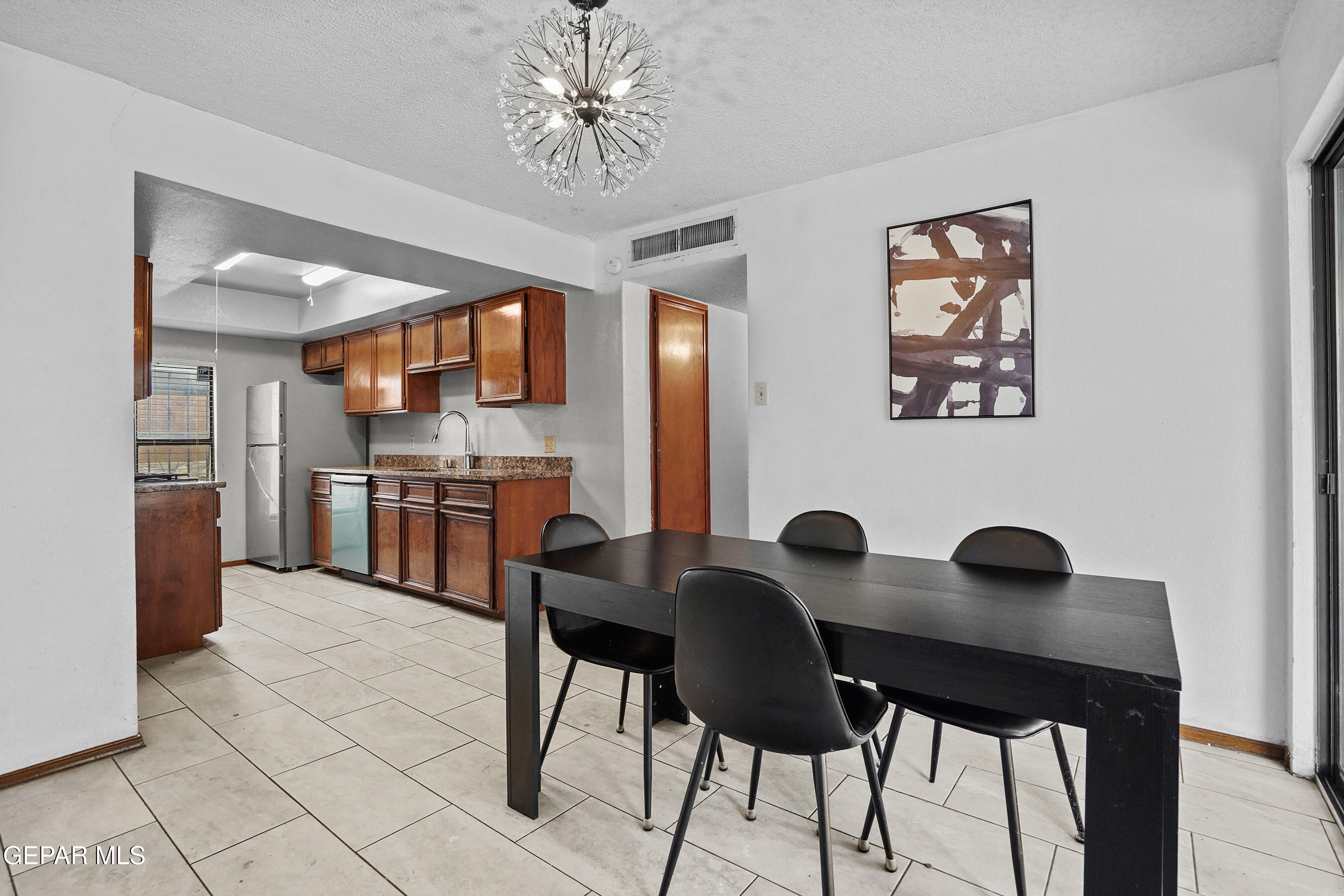 6900 Ridge Top Drive El Paso, TX 79904 - Photo 14 of 32 a view of a dining room with furniture and a chandelier