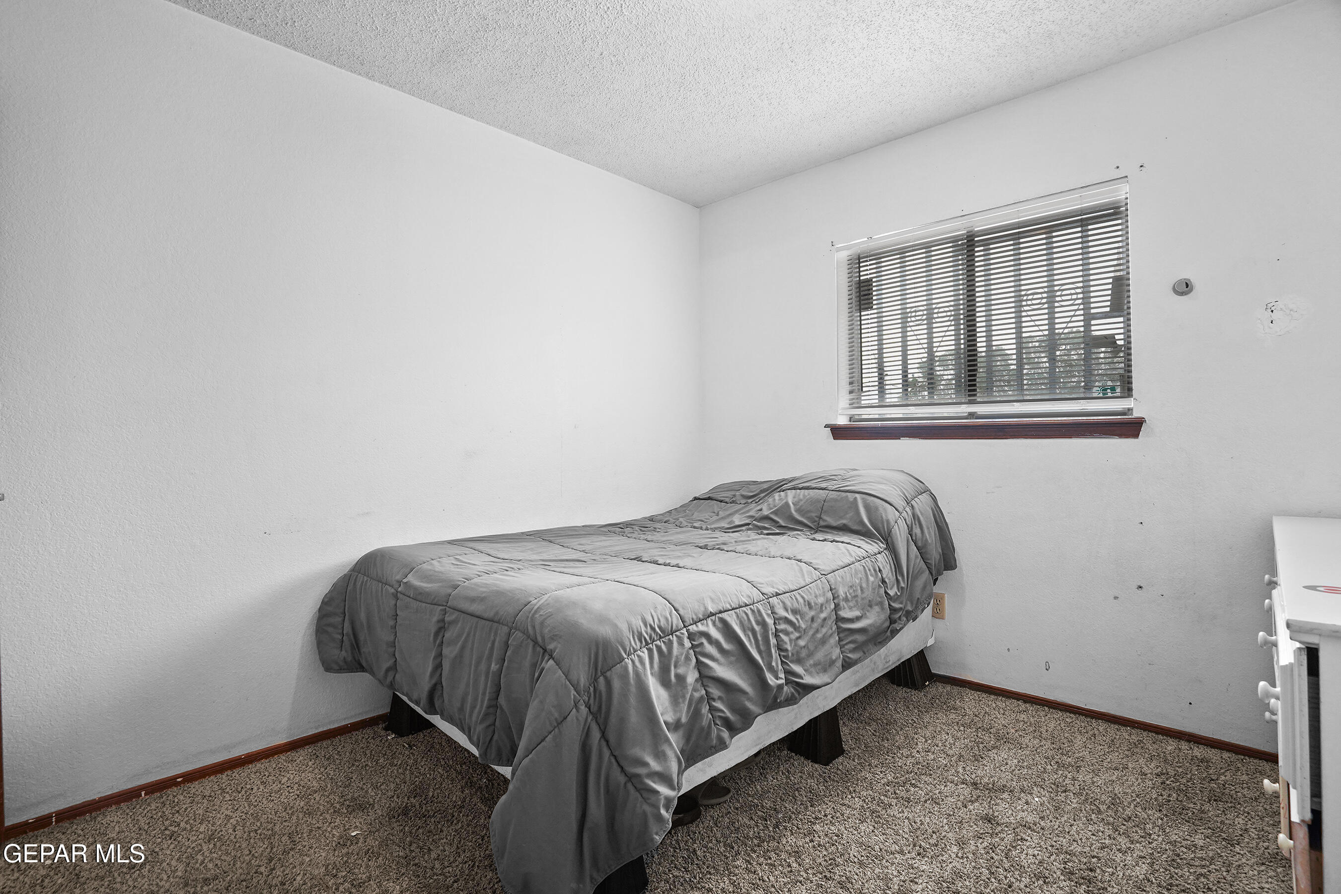 6900 Ridge Top Drive El Paso, TX 79904 - Photo 17 of 32 a bed sitting in a bedroom next to a window