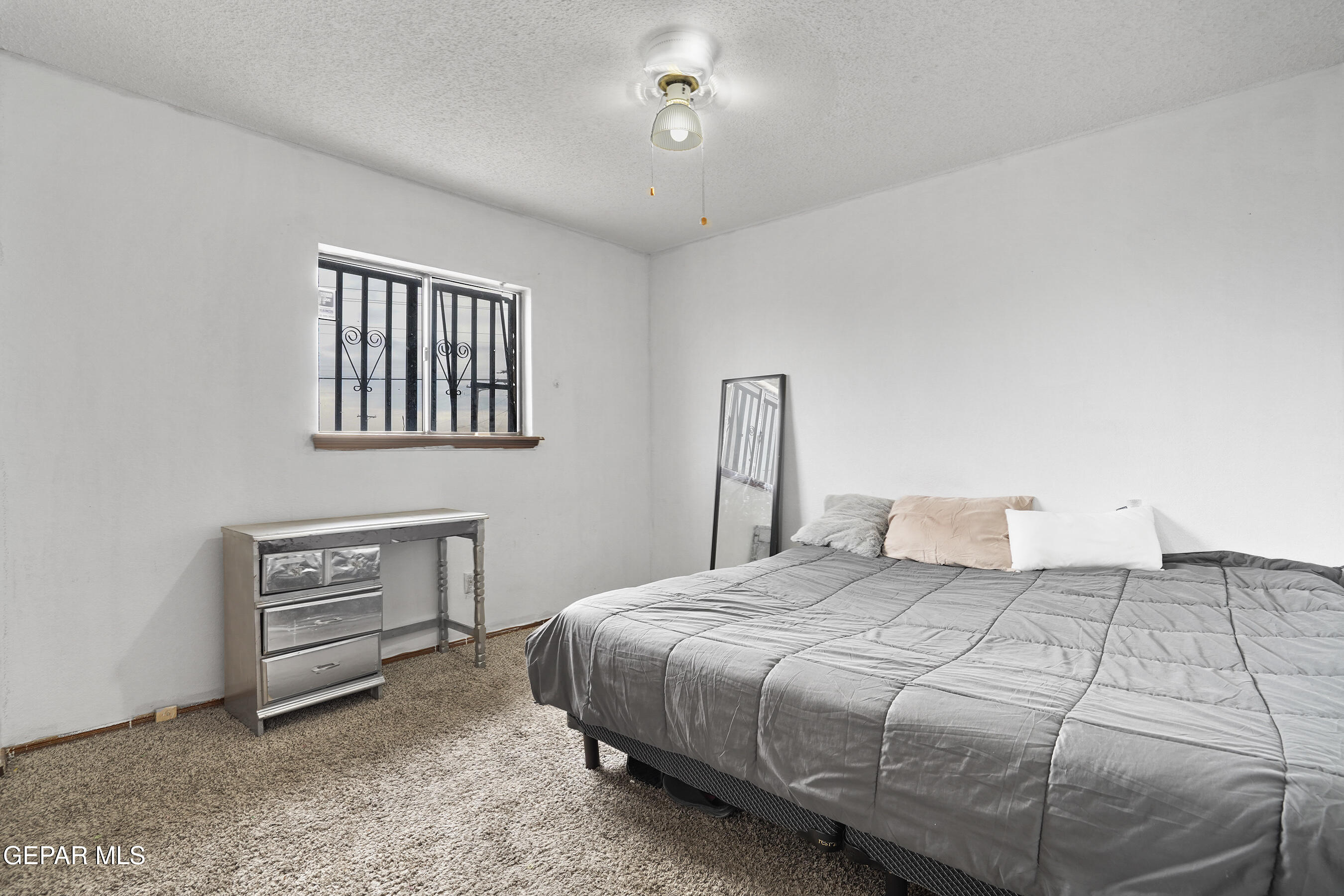 6900 Ridge Top Drive El Paso, TX 79904 - Photo 19 of 32 a bedroom with a bed and a painting on the wall