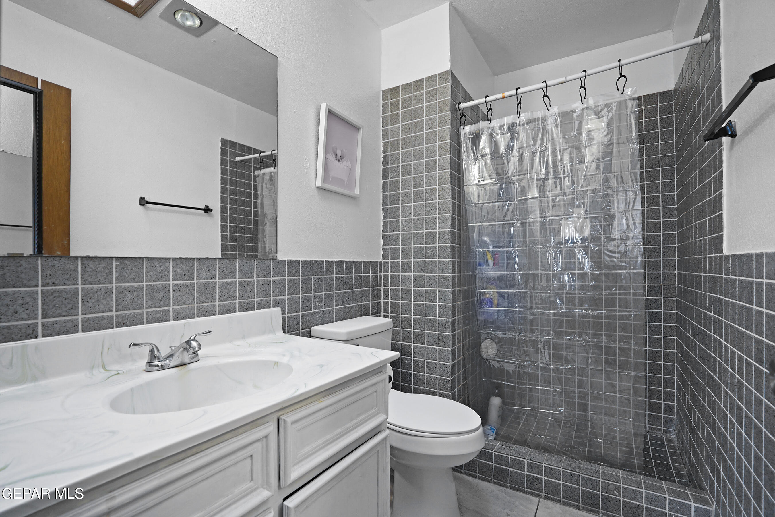 6900 Ridge Top Drive El Paso, TX 79904 - Photo 24 of 32 a bathroom with a sink toilet and shower