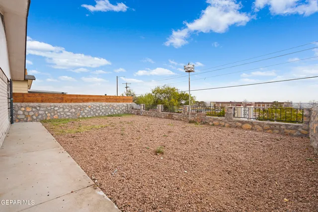 an aerial view of residential houses with outdoor space and parking