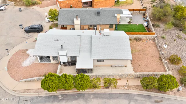 an aerial view of a house with a yard