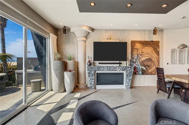 a living room with furniture a fireplace and a flat screen tv