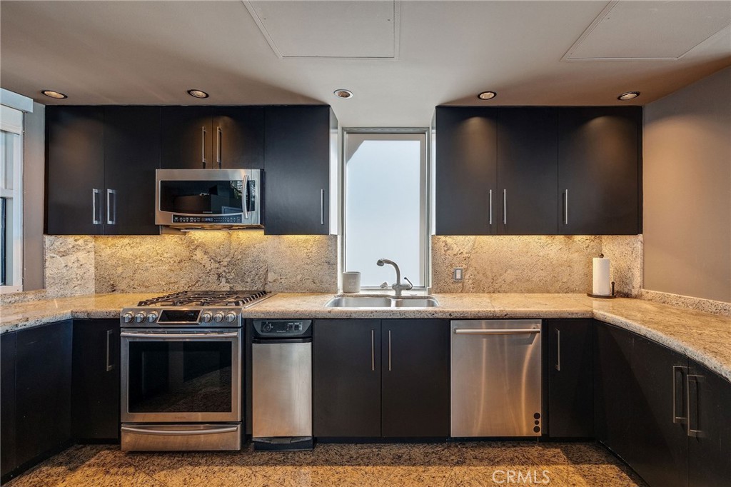 2024 The Strand Hermosa Beach, CA 90254 - Photo 17 of 65 a kitchen with a sink and a microwave
