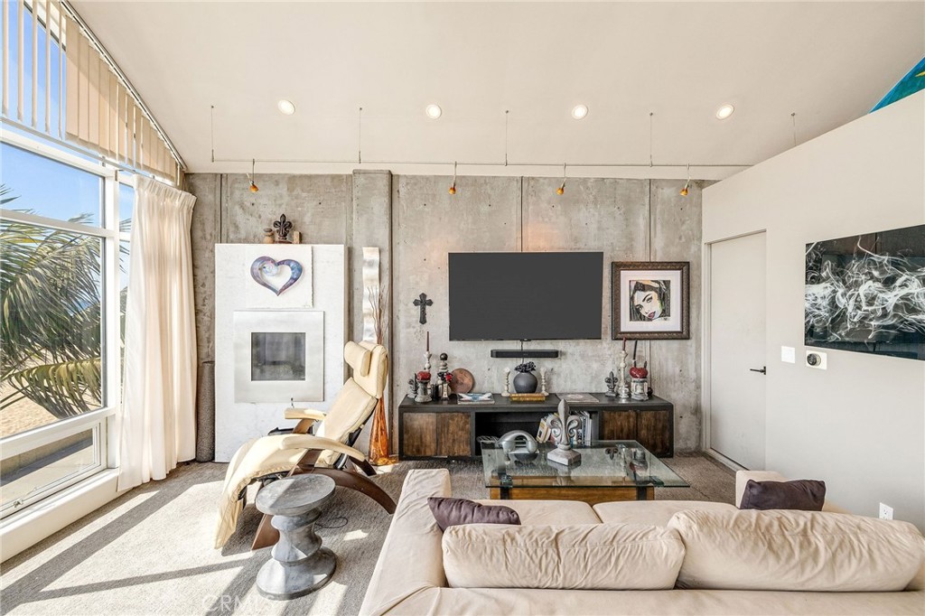 2024 The Strand Hermosa Beach, CA 90254 - Photo 36 of 65 a living room with furniture and a flat screen tv