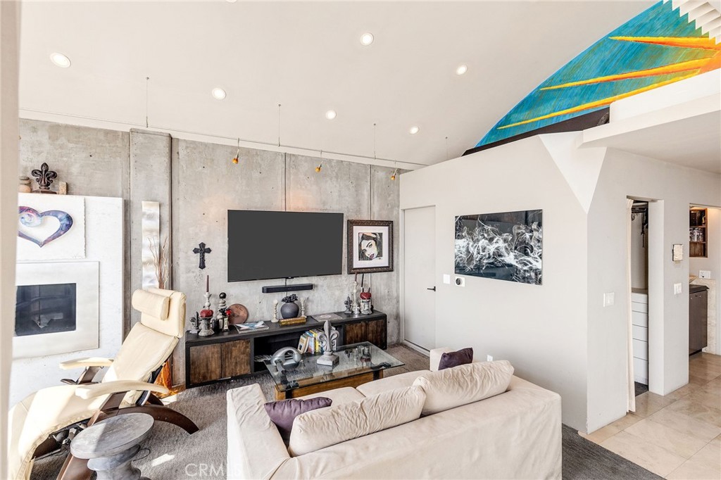 2024 The Strand Hermosa Beach, CA 90254 - Photo 37 of 65 a living room with furniture and a flat screen tv