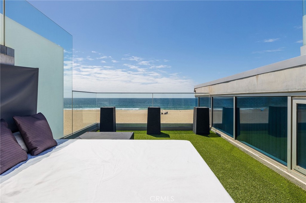 2024 The Strand Hermosa Beach, CA 90254 - Photo 39 of 65 a bedroom with a bed and large window