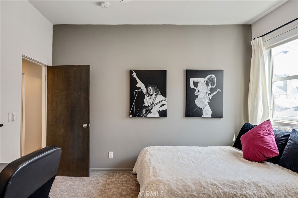 2024 The Strand Hermosa Beach, CA 90254 - Photo 53 of 65 a bedroom with a bed and wall painting