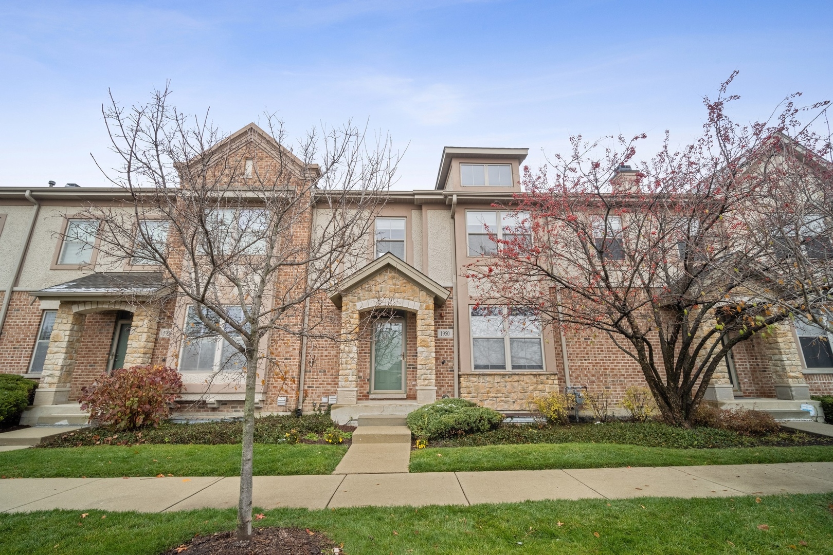 a front view of a house with a yard