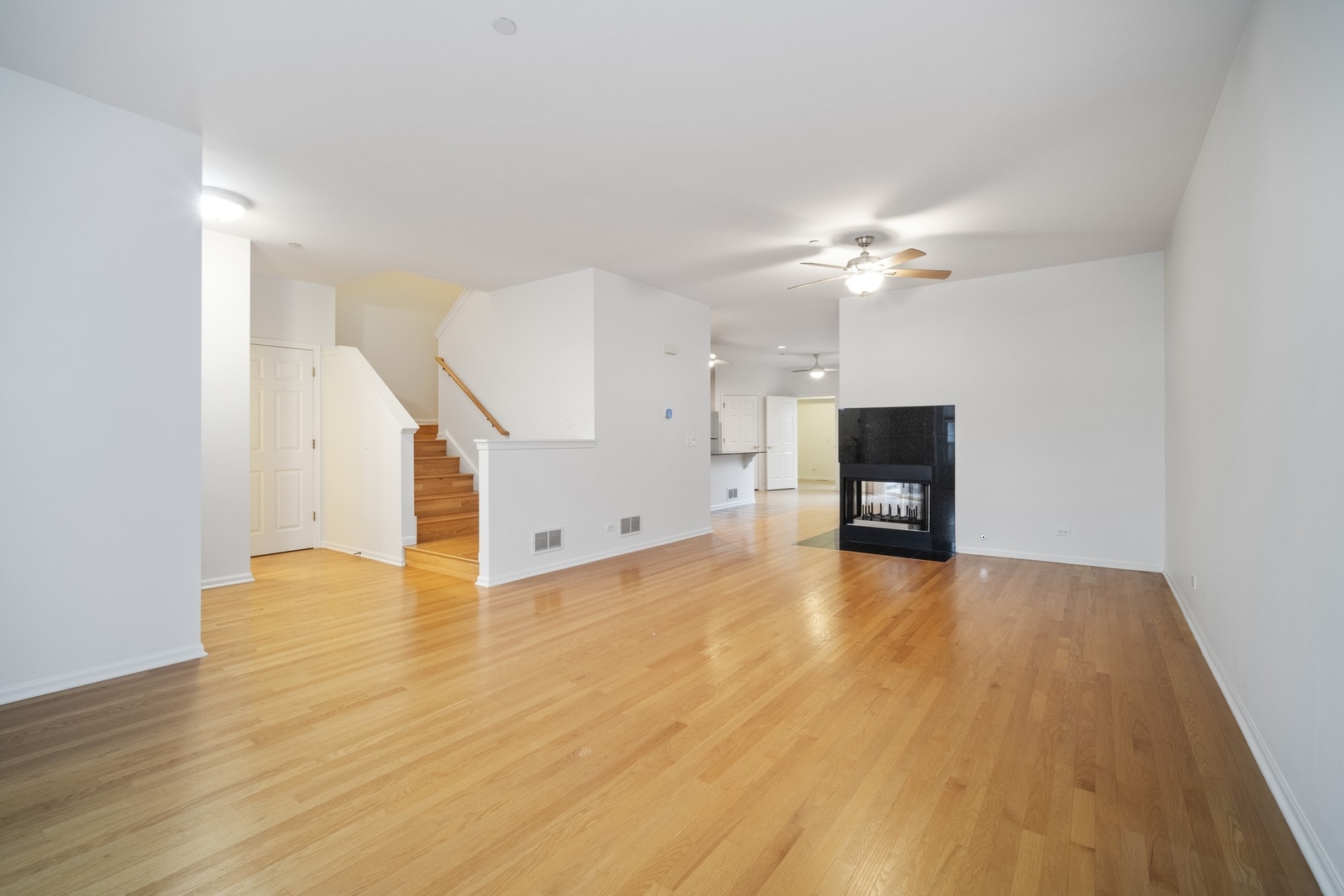 1950 Beaumont Place Northbrook, IL 60062 - Photo 2 of 10 a view of an empty room with a fireplace and wooden floor