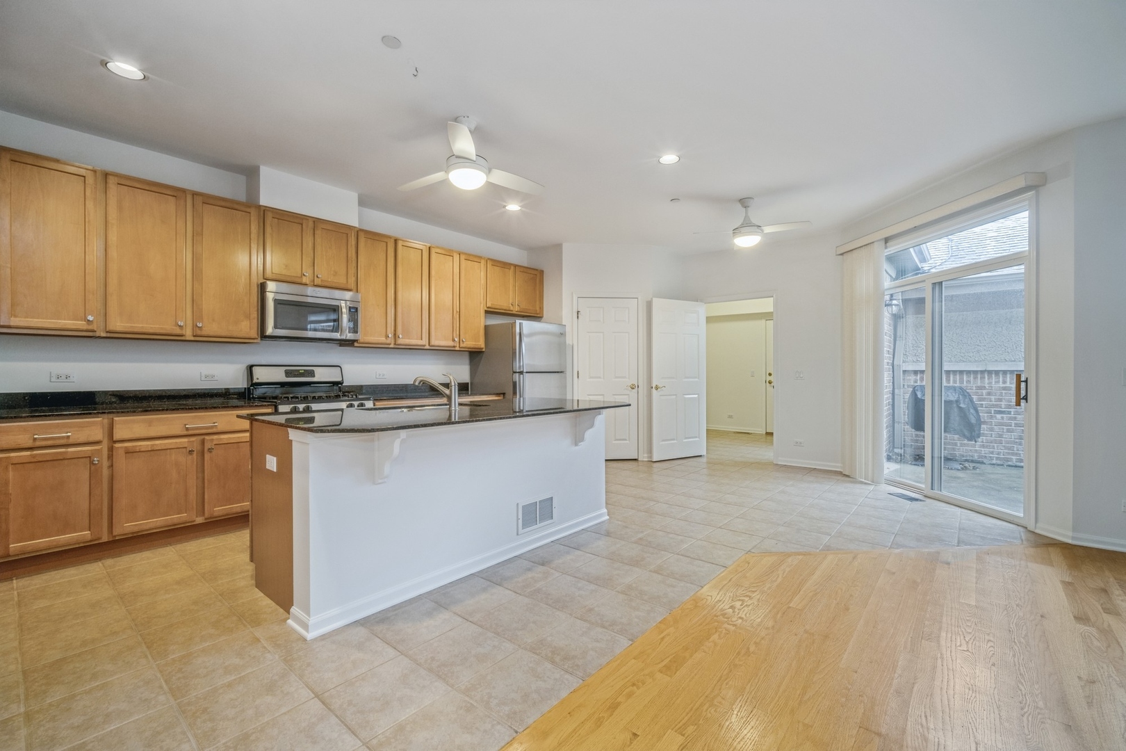1950 Beaumont Place Northbrook, IL 60062 - Photo 3 of 10 a kitchen with stainless steel appliances granite countertop a stove a sink and a refrigerator