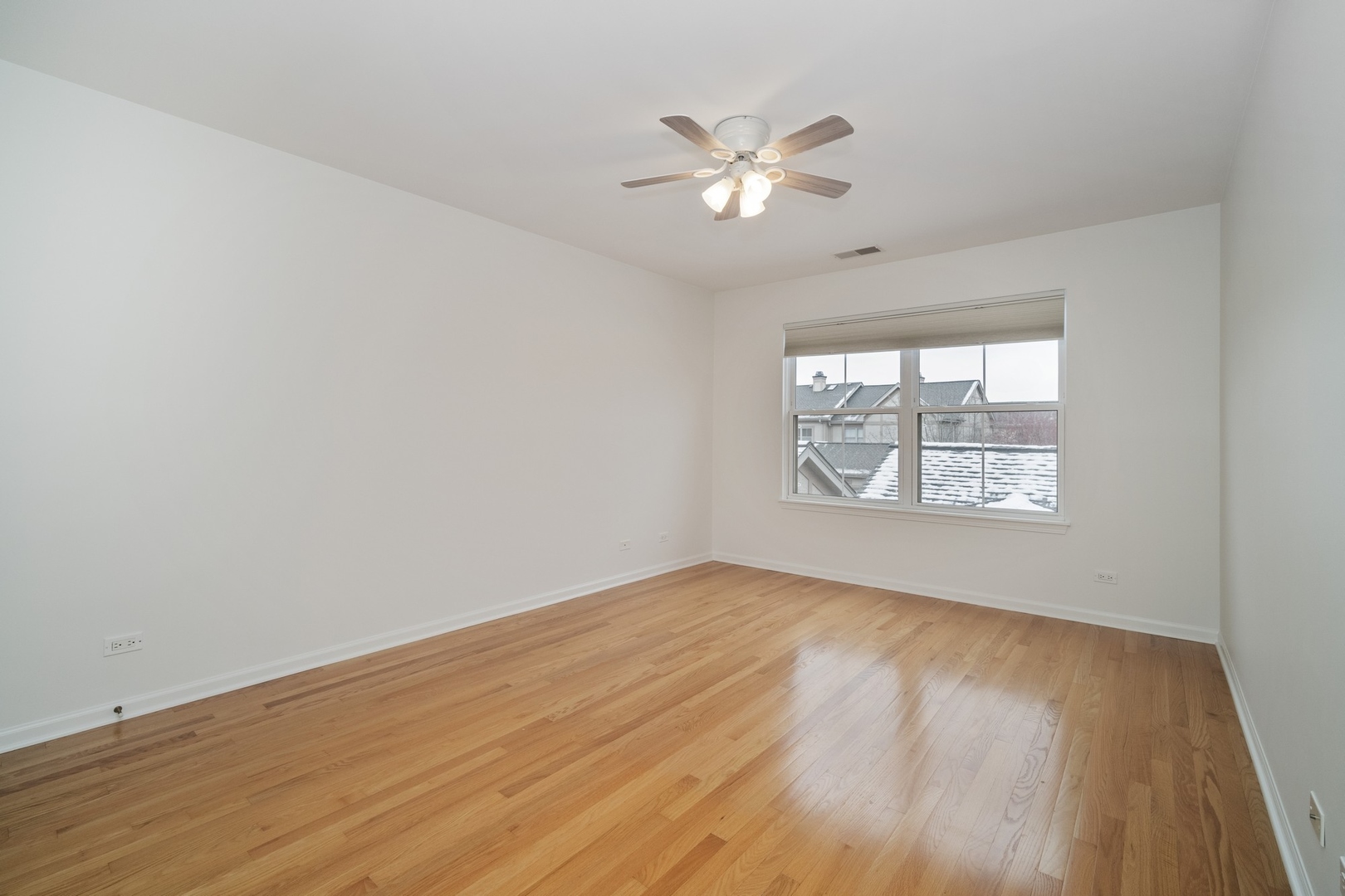 1950 Beaumont Place Northbrook, IL 60062 - Photo 7 of 10 a view of an empty room with wooden floor and a window