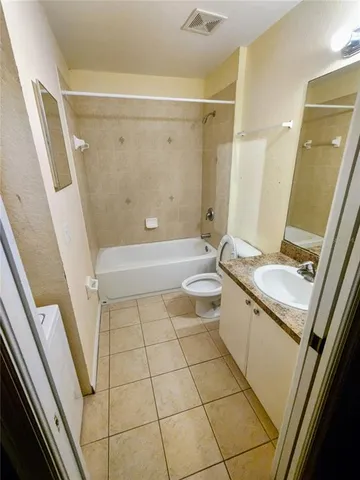 a white bath tub sitting next to a toilet and sink