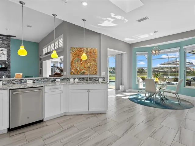 a kitchen with granite countertop a refrigerator and a sink