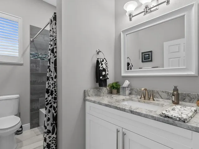 a view of a workspace with furniture and a bookshelf