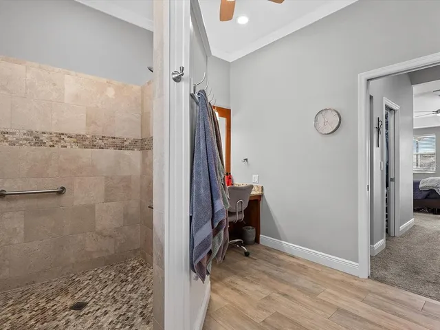 a view of a swimming pool with chairs and tables in patio