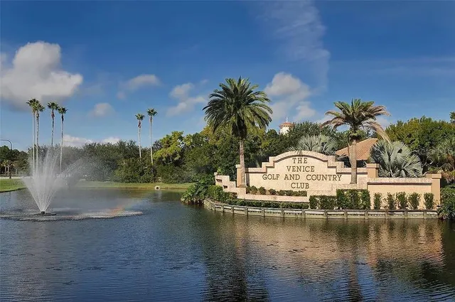 a view of a house with swimming pool and sitting area