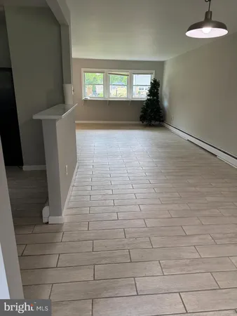 a view of empty room with window and fireplace
