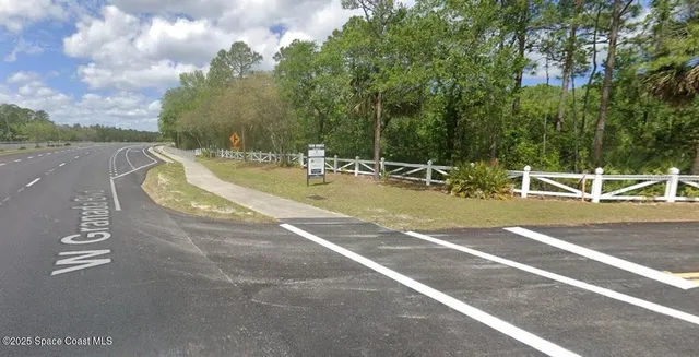a view of a playground with basketball court