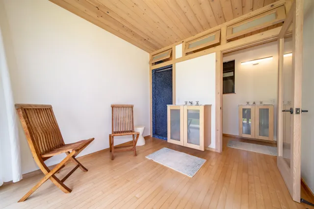 a view of a hallway with wooden floor and furniture