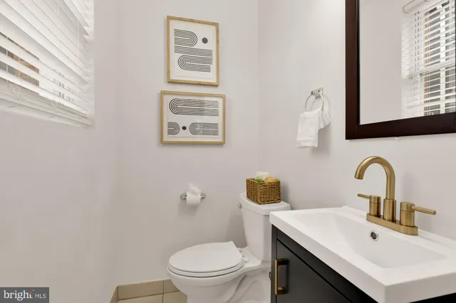 a bathroom with a sink mirror and toilet