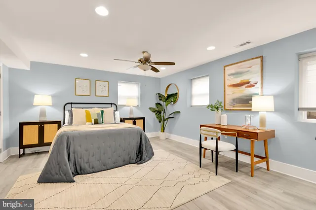 a bedroom with a bed and a potted plant