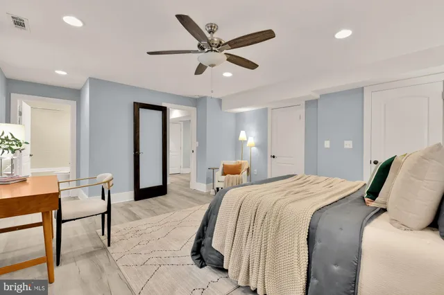 a bed room with a bed and a chair