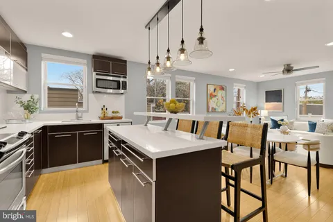 a large kitchen with a table and chairs