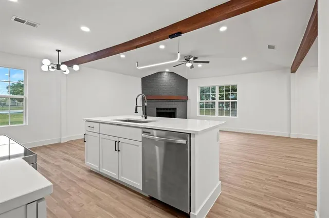 a kitchen with a sink and chandelier