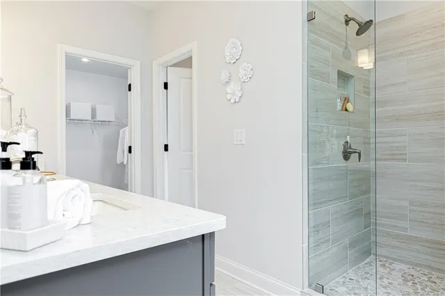 a view of walk in closet with clothes and shoes