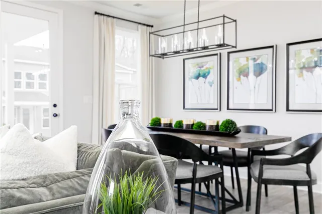 a kitchen with stainless steel appliances white cabinets sink and wooden floor