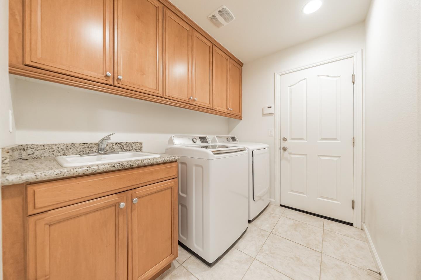 3830 Highbury Way San Ramon, CA 94582 - Photo 11 of 38 a utility room with granite countertop cabinets washer and dryer