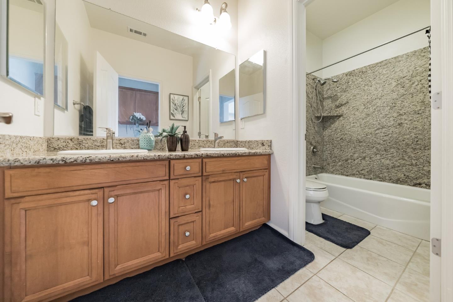 3830 Highbury Way San Ramon, CA 94582 - Photo 19 of 38 a bathroom with a granite countertop sink a toilet and bathtub