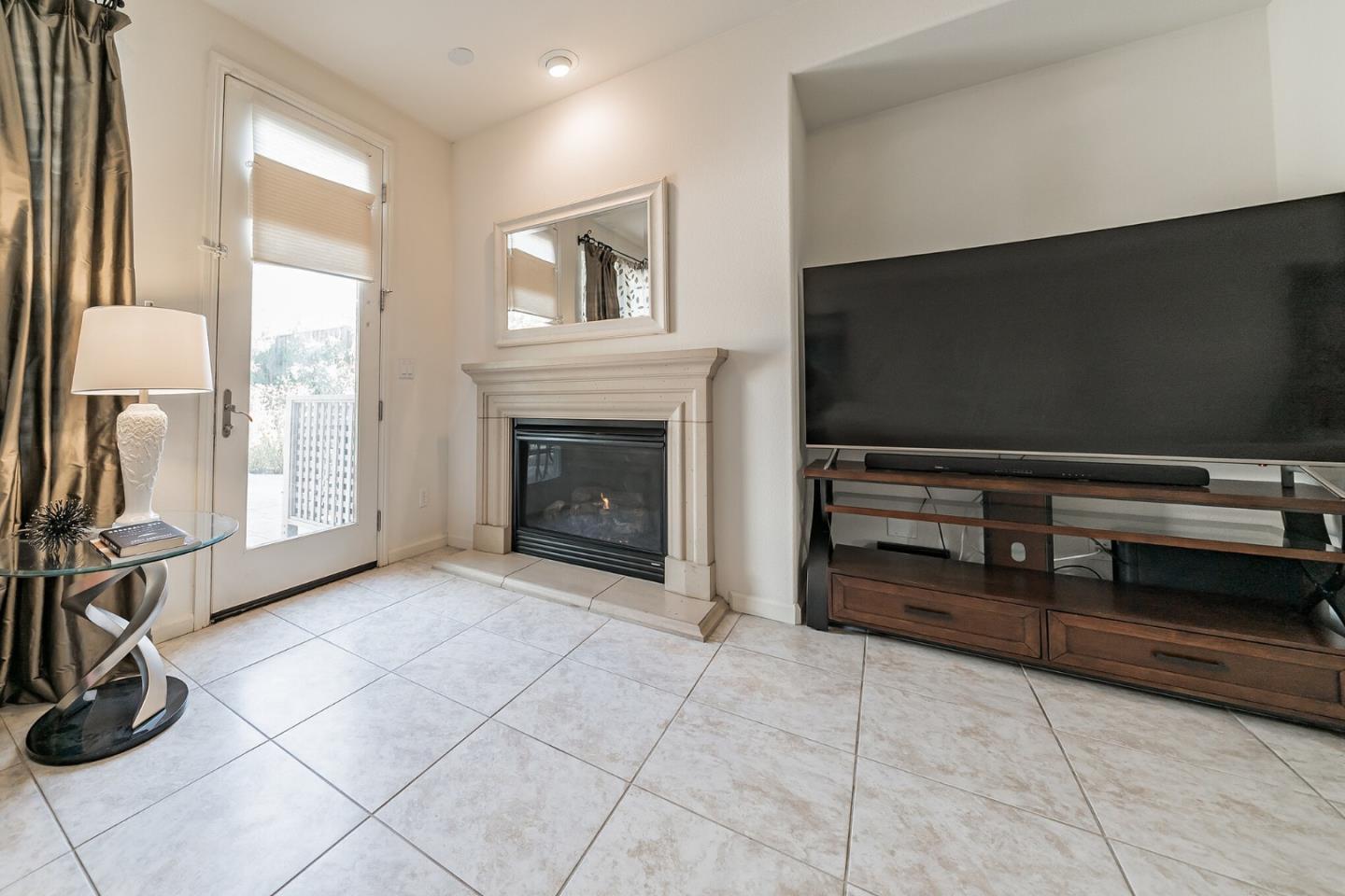 3830 Highbury Way San Ramon, CA 94582 - Photo 26 of 38 a living room with furniture a flat screen tv and a fireplace