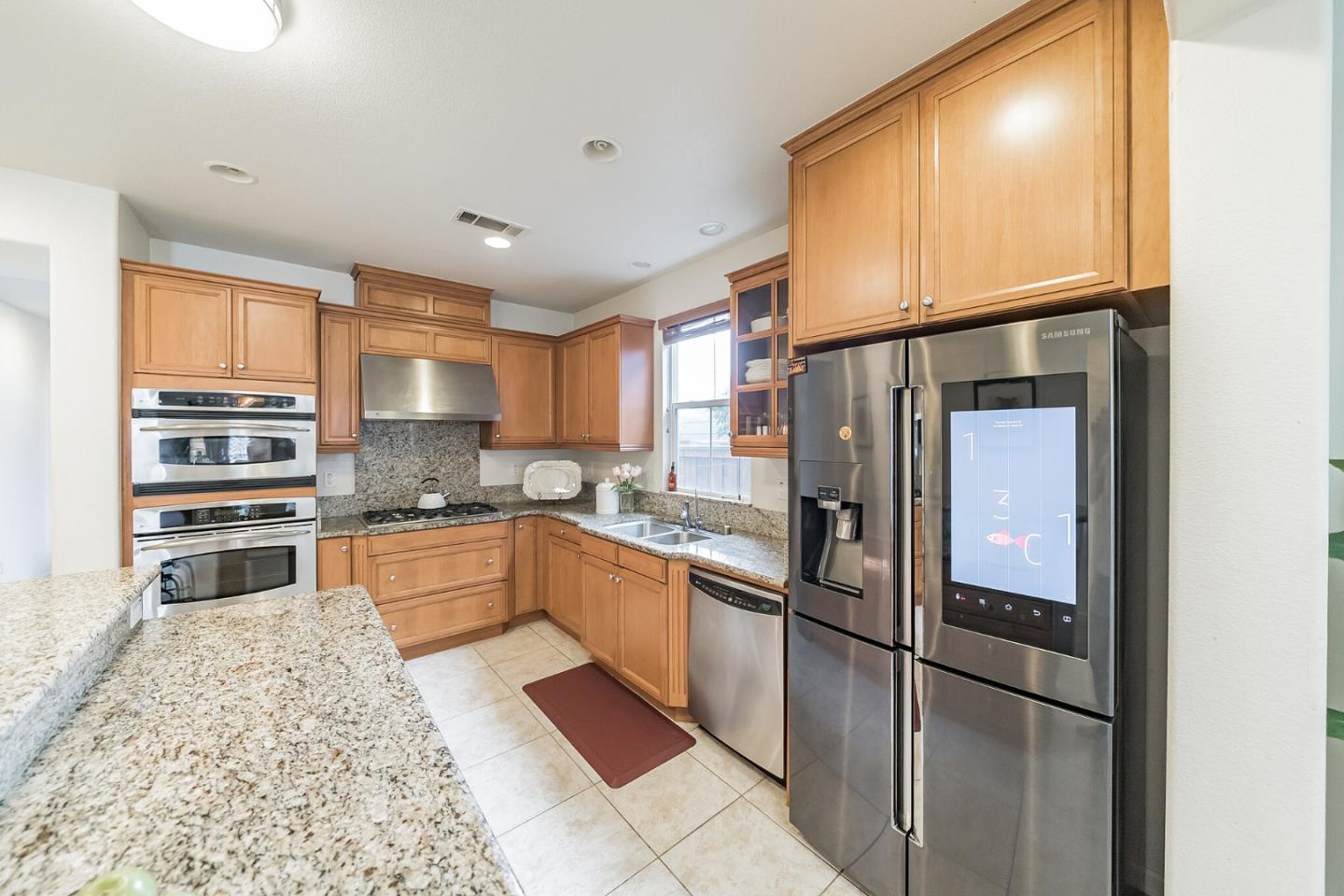 3830 Highbury Way San Ramon, CA 94582 - Photo 10 of 38 a kitchen with stainless steel appliances granite countertop a refrigerator a stove and a sink with cabinets