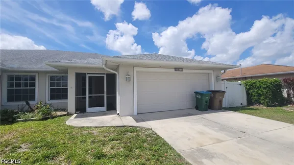 a front view of a house with a yard and garage