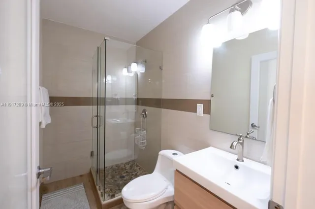 a bathroom with a sink toilet and shower