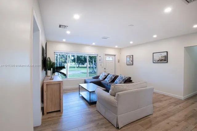 a living room with furniture and a large window