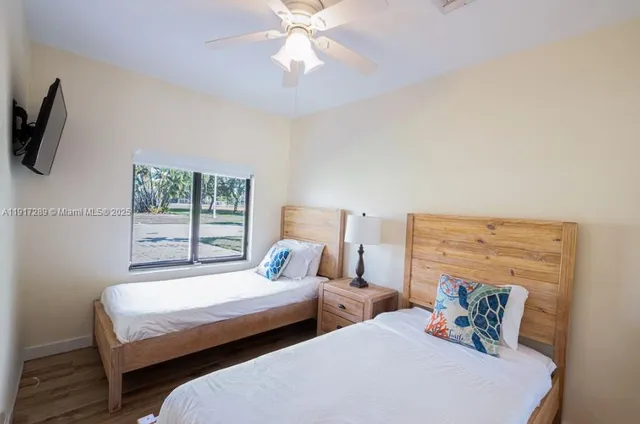 a bedroom with two beds and a chandelier