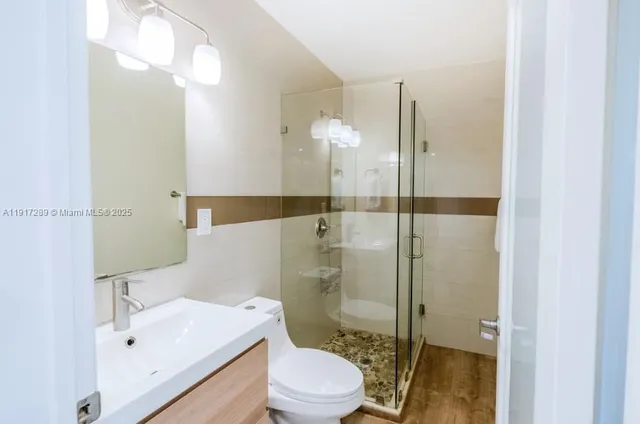 a bathroom with a sink toilet and shower