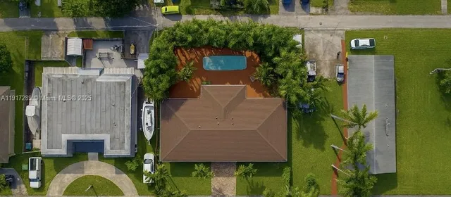 an aerial view of a house with swimming pool garden and patio