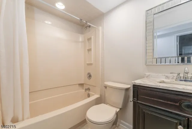 a bathroom with a sink toilet vanity and shower